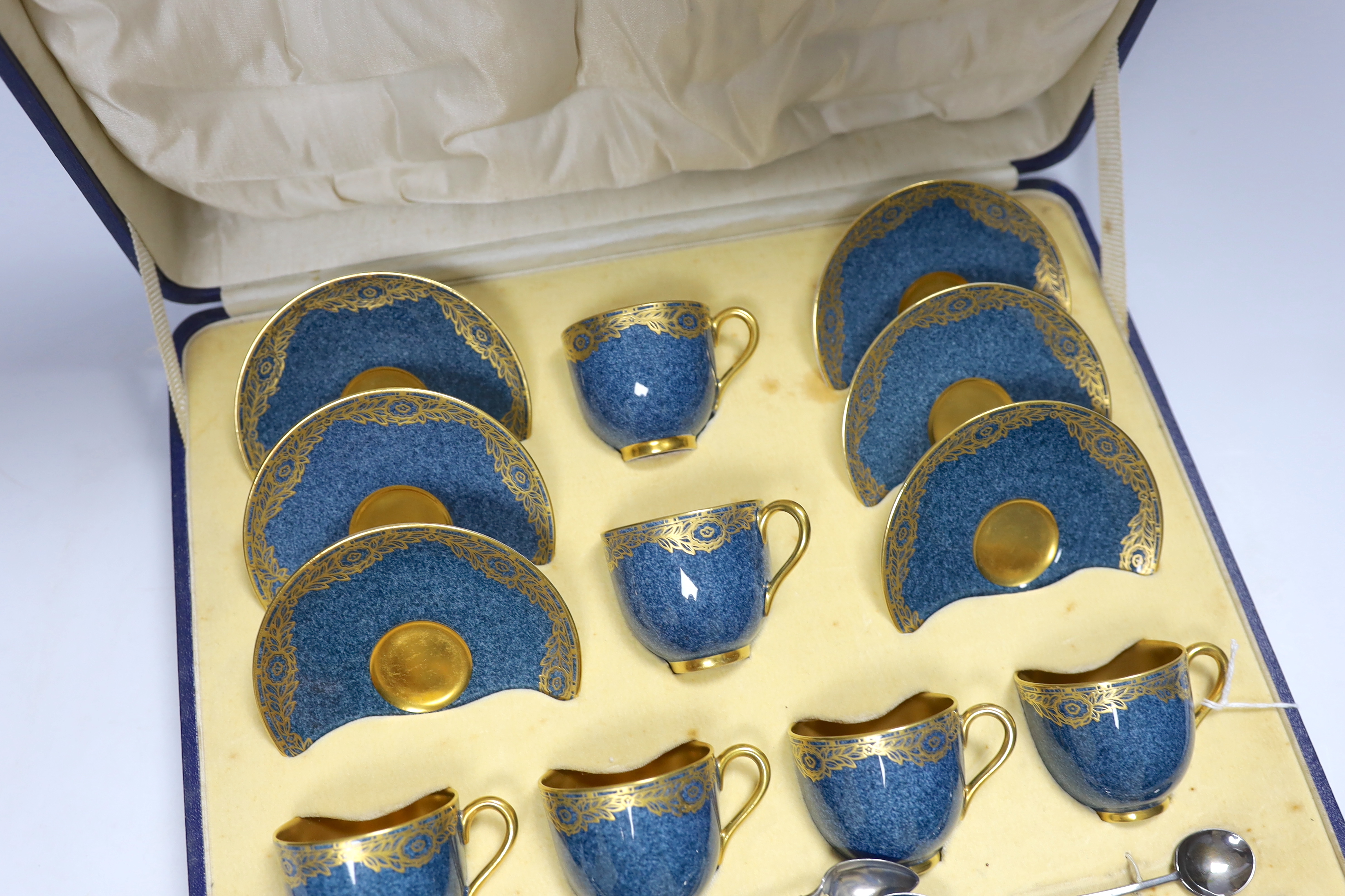 A cased Royal Worcester gilt and powder blue six piece coffee set with silver teaspoons, set of six silver and guilloche enamel teaspoons together with a Meissen blue and white ‘onion pattern’ serving dish, 39cm wide